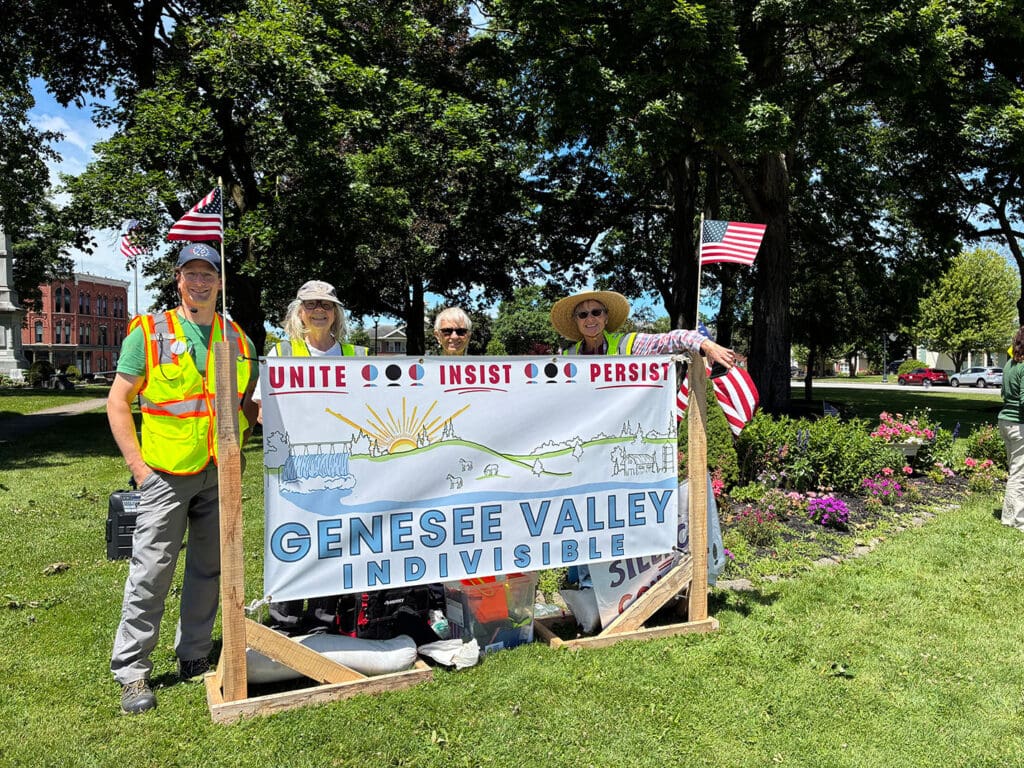 Genesee Valley Indivisible members holding banner outdoors